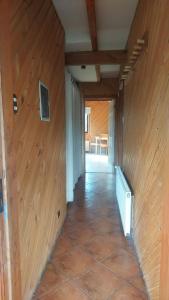 a hallway of a house with a wooden wall at MI Lodge Las Trancas Hotel & Spa in Las Trancas