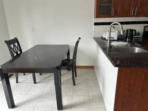 a kitchen with a black table and a sink at HomeNet in Toronto