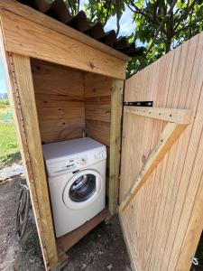 a washer and dryer in a wooden structure at Tente Cocoon in La Brillanne +25 photos