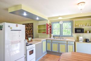 a kitchen with a white refrigerator and a sink at Tranquil Cozy Cottage Recently Renovated in Wellfleet