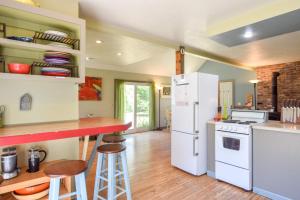 a kitchen with a white refrigerator and a counter at Tranquil Cozy Cottage Recently Renovated in Wellfleet
