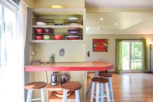 a kitchen with a counter and stools in a room at Tranquil Cozy Cottage Recently Renovated in Wellfleet