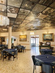 a dining room with blue tables and chairs at Hotel Chopin in Fiumicino