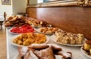 a buffet with many different types of pastries on plates at Aleksov Complex Aleksion Palace in Ognyanovo