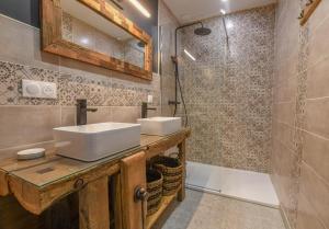a bathroom with two sinks and a shower at Le charme du moulin in Beauvoir-sur-Sarce +32 photos