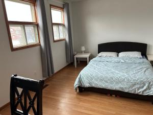 a bedroom with a bed and two windows at HomeNet in Toronto +4 photos