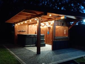 a gazebo with a bath tub and lights at Gawędówka in Czchów