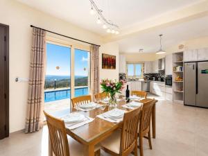 a kitchen and dining room with a table and chairs at Villa Christel in Lachi