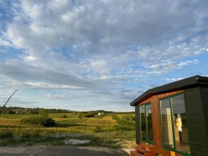 a small building with a view of a field at Green Camp Resort in Hereclean