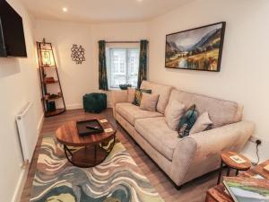 a living room with a couch and a table at Hidden Gem in Windermere