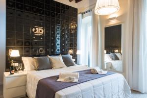 a hotel room with two beds and two lamps at LuxurYenne B&B in Cagliari