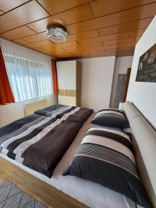 a bedroom with a large bed with black pillows at Au 10 in St. Wolfgang