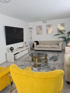 a living room with a couch and a table at Fv Dwelling in Hucknall