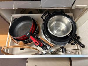a kitchen utensils and pans in a drawer at Outdoor Station 秋谷 in Yokosuka