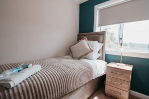 a small bedroom with a bed with a window at The Livingston Nest in Livingston +13 photos
