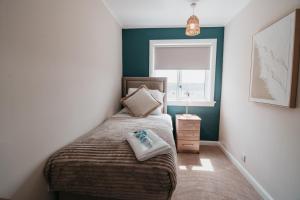 a small bedroom with a bed and a window at The Livingston Nest in Livingston