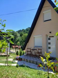 a house with a picnic table on the front porch at Vila SVITAC Banja Vrujci in Mionica
