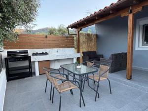 a patio with a table and chairs and a kitchen at Emerald Dream Oasis Studio in Skala Potamias