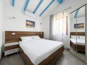 a bedroom with a large bed and a mirror at Casa Lebăda in Jurilovca
