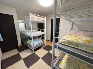 a dorm room with two bunk beds in it at Outdoor Station 秋谷 in Yokosuka