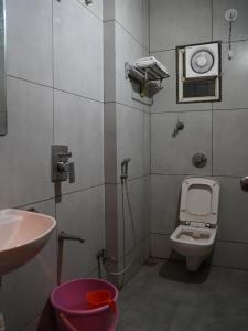 a small bathroom with a toilet and a sink at Hotel Trimurti Executive in Dāpuri