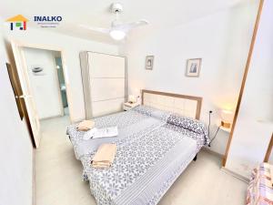 a bedroom with a bed and a mirror at Cala Montero - Inalko in Alcossebre +14 photos