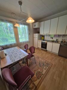 a kitchen with a table and chairs in a room at MiniMani House with Sauna in Sorsakoski