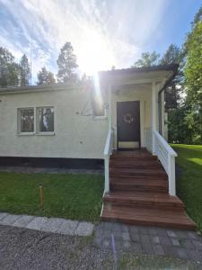 a house with a staircase leading to the front door at MiniMani House with Sauna in Sorsakoski