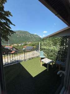 a balcony with a bench and a view of a mountain at WIN apartment in Plužine