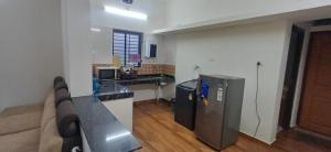a kitchen with a refrigerator and a counter top at AGM Spacious Private AC 1BHK with Hall, Kitchen & Bath in Udupi +10 photos