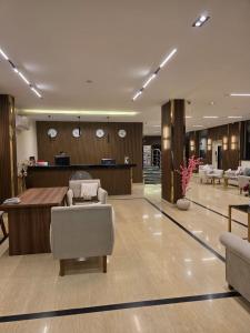 a lobby of a hotel with chairs and a reception desk at Dyafa Pyramids Hotel in Cairo