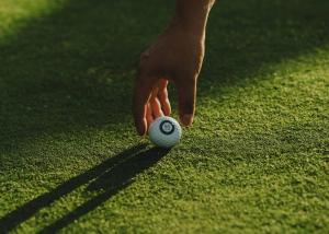 a person holding a golf ball on the grass at Domaine Golf Saint-Lazare in Limoges
