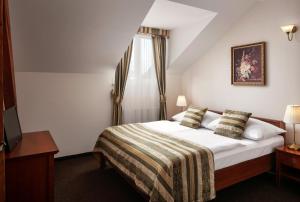 a hotel room with a bed and a window at Amigo City Centre in Prague