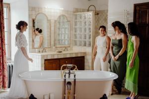 a group of women standing next to a bath tub at Château de Tournou in Castelreng +65 photos