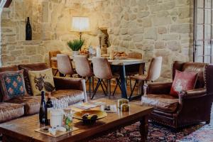 a living room with a table and chairs at Château de Tournou in Castelreng