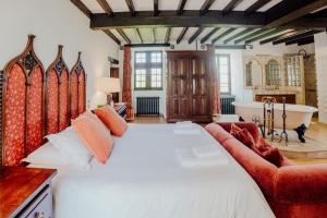 a bedroom with a large bed and a bath tub at Château de Tournou in Castelreng