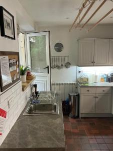 a kitchen with a sink and a counter top at Middle Cottage in Middleham