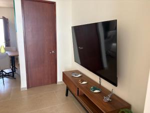 a living room with a large flat screen tv on a wall at San Francisco Cancun in Cancún