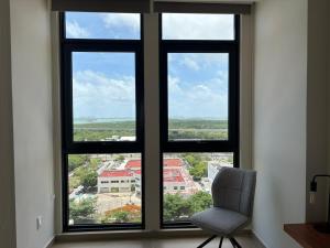 a chair sitting in front of a window with a view at San Francisco Cancun in Cancún +85 photos