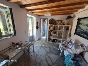 a living room with a couch and a table at Charmante maison cycladique traditionnelle in Faros +9 photos