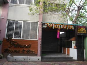 a building with a gate and a sign on it at Hotel Trimurti Executive in Dāpuri