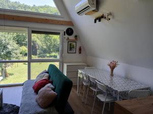 a living room with a table and a couch at Vila SVITAC Banja Vrujci in Mionica