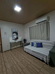 a bedroom with a bed with blue pillows on it at Casa Privativa com Piscina, Churrasqueira, Wi-Fi e Ar-Condicionado em Manaus in Manaus +34 photos