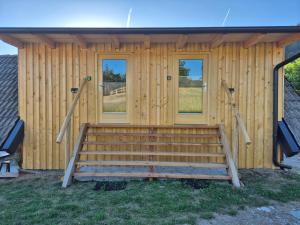 a log cabin with a bench in front of it at Glamping Gril in Ljubno