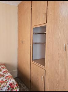 a wooden cabinet in a bedroom with a bed at Peace and Quiet accomodation in Richards Bay