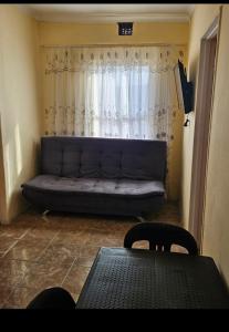a couch in a living room with a window at Peace and Quiet accomodation in Richards Bay