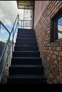 a set of stairs next to a brick wall at Peace and Quiet accomodation in Richards Bay +3 photos