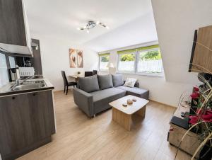 a living room with a couch and a table at Wald Villa Üssbach in Alf