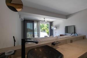 a bedroom with a large bed and a window at Gyra Villas - Seaview Villa Fivos with private pool in Lefkada