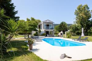 a villa with a swimming pool and a house at Gyra Villas - Seaview Villa Fivos with private pool in Lefkada